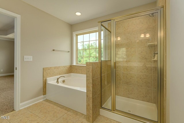 bathroom with tile patterned flooring and shower with separate bathtub