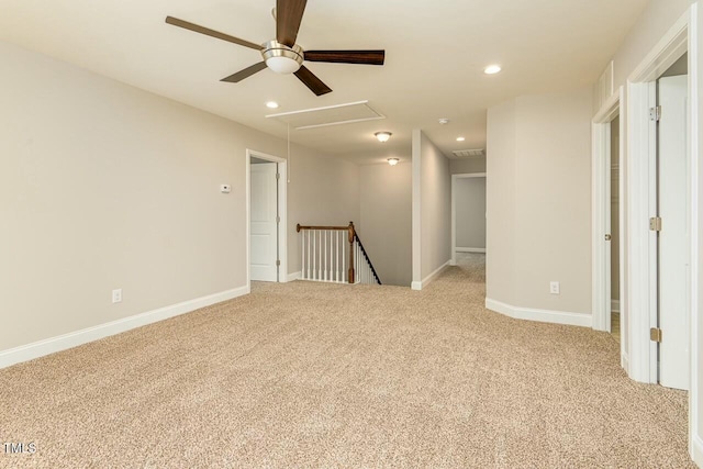 carpeted spare room featuring ceiling fan