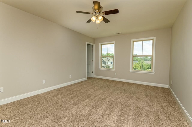 spare room featuring carpet and ceiling fan