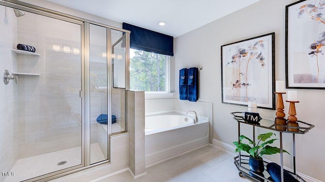 bathroom featuring tile patterned floors and shower with separate bathtub