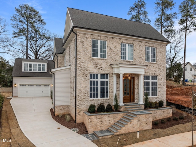 view of front of house with a garage, driveway, and brick siding