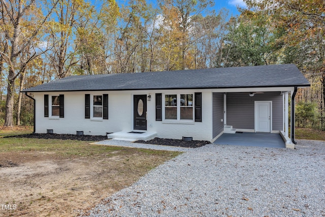 1518 Parks Village Rd, Zebulon, NC 27597 - single story home with a shingled roof, crawl space, an attached carport, driveway, and brick siding