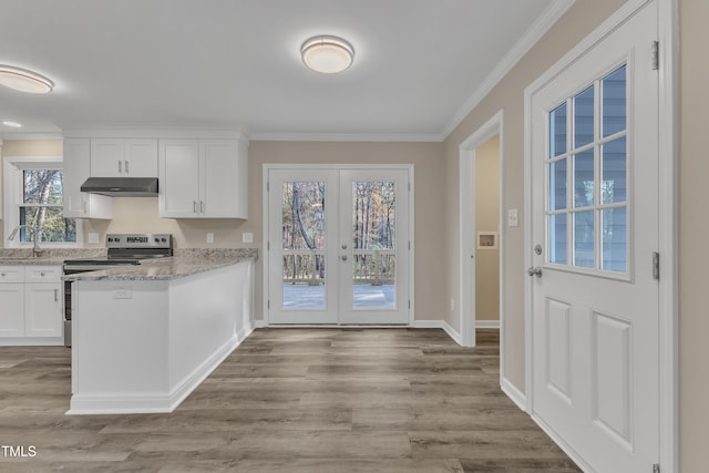 1518 Parks Village Rd, Zebulon, NC 27597 - kitchen featuring french doors, electric stove, light hardwood / wood-style flooring, light stone counters, and white cabinetry