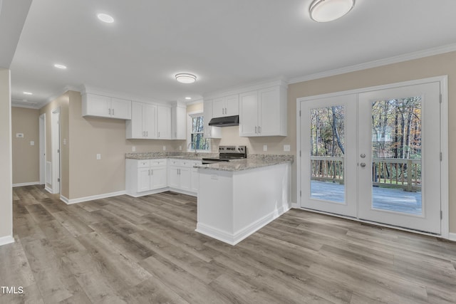 1518 Parks Village Rd, Zebulon, NC 27597 - kitchen with french doors, white cabinets, electric stove, sink, and light hardwood / wood-style floors