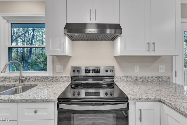 1518 Parks Village Rd, Zebulon, NC 27597 - kitchen featuring electric stove, ventilation hood, a sink, and white cabinetry