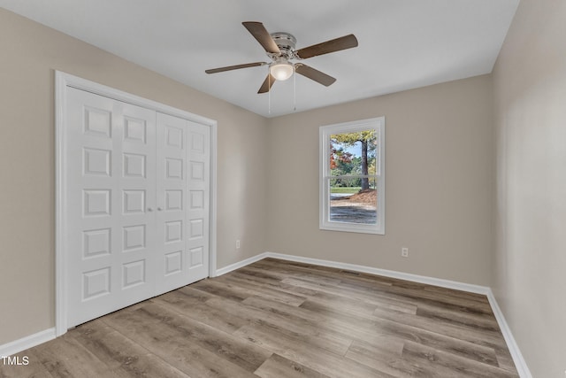 1518 Parks Village Rd, Zebulon, NC 27597 - unfurnished bedroom featuring ceiling fan, a closet, and light wood-type flooring