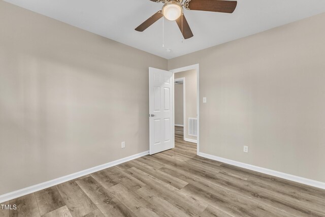 1518 Parks Village Rd, Zebulon, NC 27597 - unfurnished room with wood finished floors, baseboards, and a ceiling fan