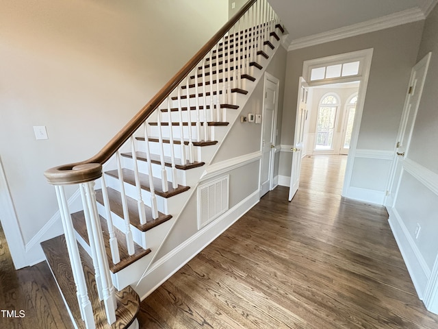 stairway featuring hardwood / wood-style flooring and ornamental molding