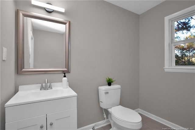 bathroom featuring tile patterned flooring, vanity, and toilet