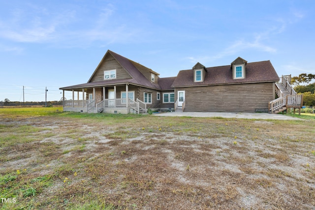 back of property with a porch