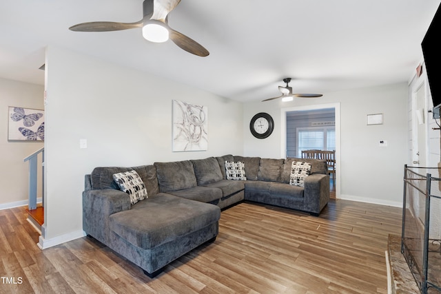 living room with ceiling fan and wood-type flooring