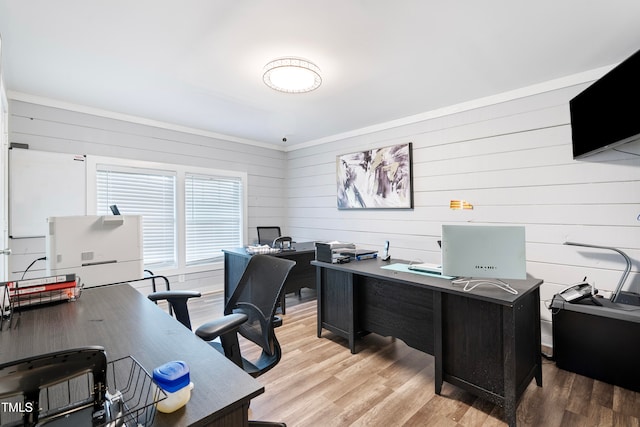 home office featuring wooden walls and light hardwood / wood-style floors