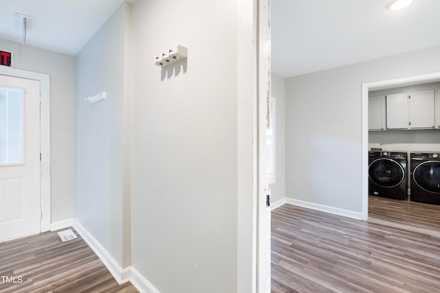 foyer entrance featuring light hardwood / wood-style flooring and washer and clothes dryer