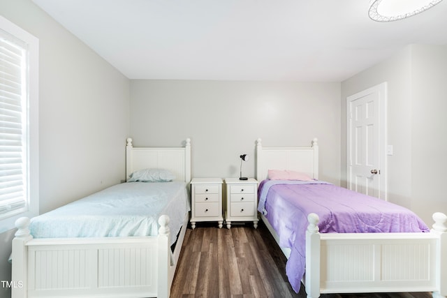 bedroom with dark hardwood / wood-style floors