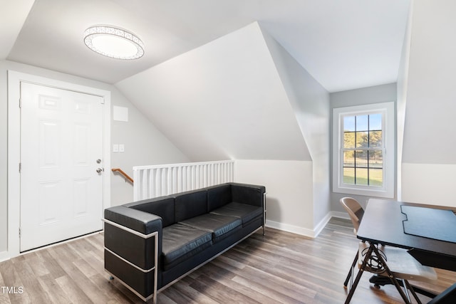 home office with wood-type flooring and vaulted ceiling