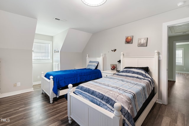 bedroom featuring vaulted ceiling, multiple windows, and dark hardwood / wood-style floors