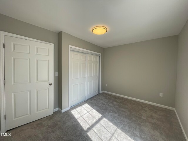 unfurnished bedroom featuring carpet and a closet