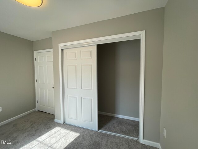 unfurnished bedroom featuring a closet and carpet