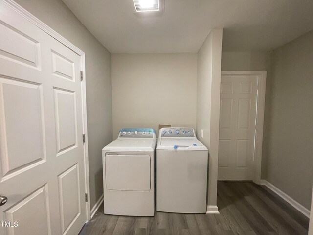 washroom featuring dark wood-type flooring and washer and dryer