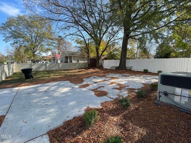 view of yard featuring cooling unit and a patio area