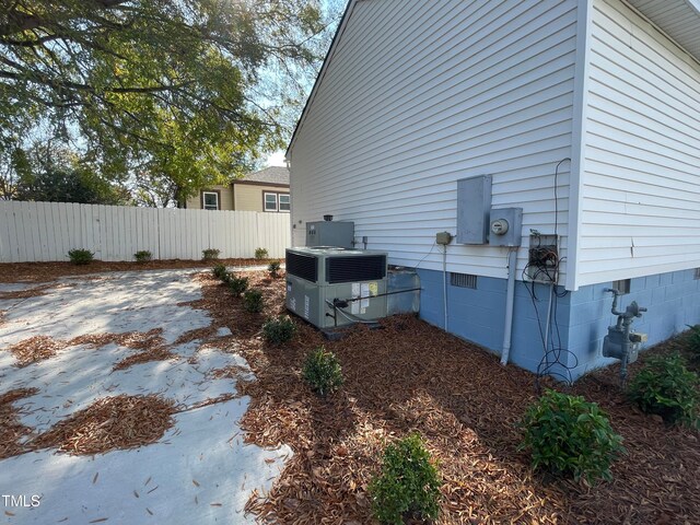 view of side of home with central air condition unit