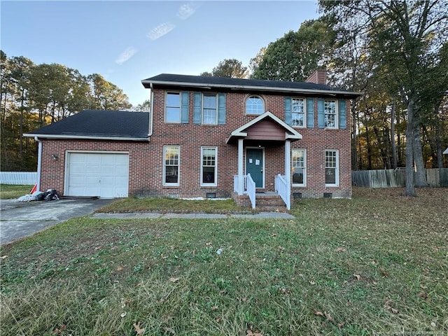 colonial-style house with a garage and a front yard