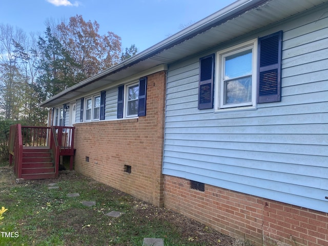 view of side of property featuring a wooden deck