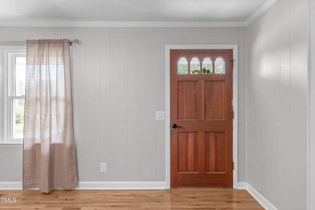 foyer entrance featuring ornamental molding and light wood-type flooring