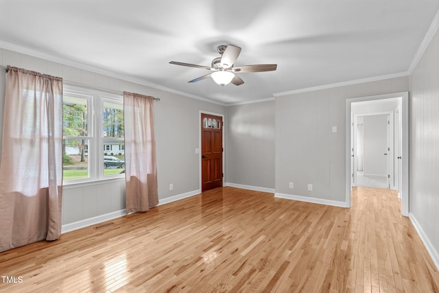 spare room featuring ceiling fan, light hardwood / wood-style flooring, and ornamental molding