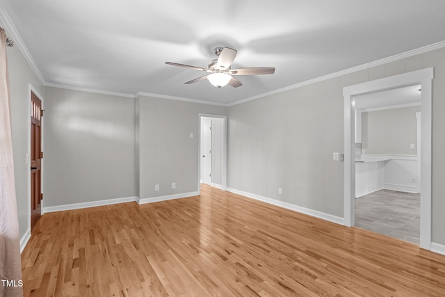 empty room with ceiling fan, crown molding, and light hardwood / wood-style flooring