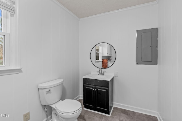 bathroom featuring electric panel, crown molding, toilet, wooden walls, and vanity