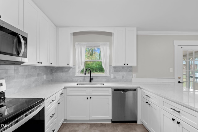 kitchen featuring white cabinetry, sink, ornamental molding, and appliances with stainless steel finishes