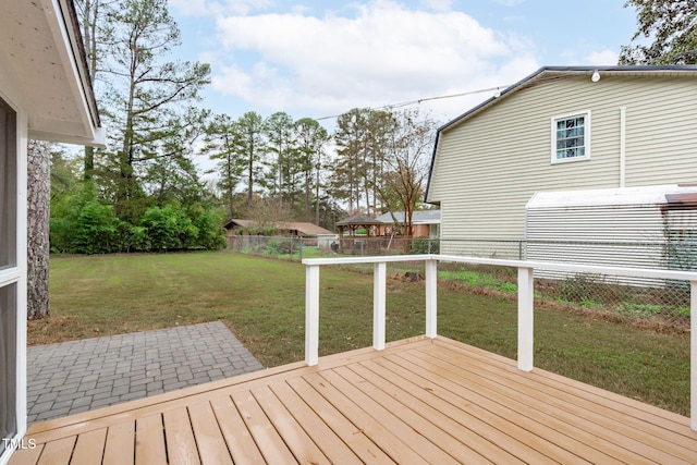 wooden terrace featuring a lawn