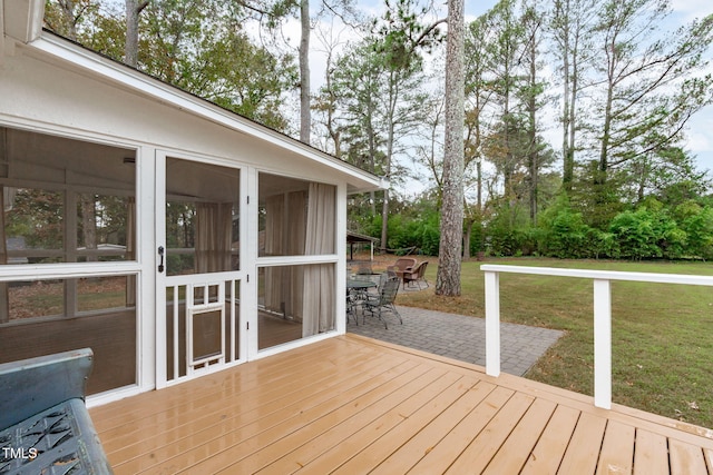 deck with a yard, a patio area, and a sunroom