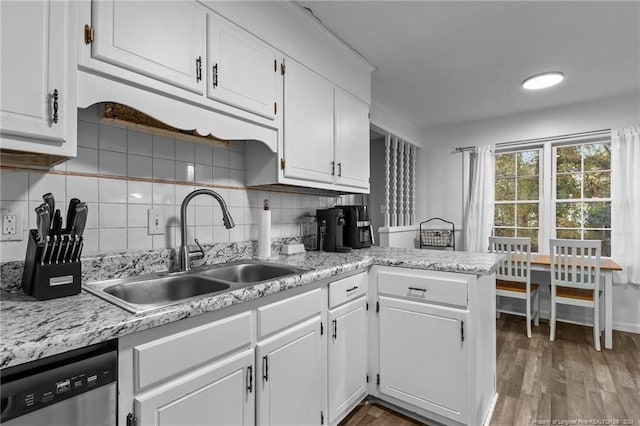 kitchen with dishwasher, backsplash, white cabinets, sink, and dark hardwood / wood-style floors