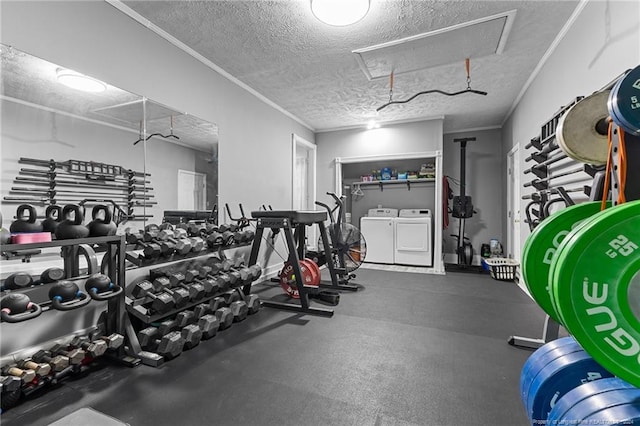 exercise room with washing machine and dryer and a textured ceiling