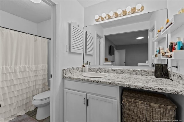 bathroom with vanity and toilet