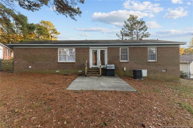 rear view of property featuring a patio area and central AC