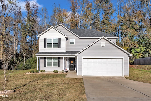 view of property featuring a garage and a front lawn