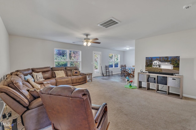 living room featuring carpet and ceiling fan