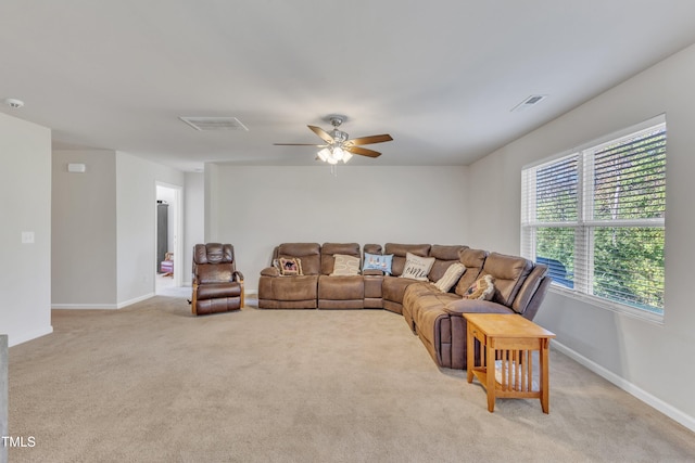 living room featuring light carpet and ceiling fan