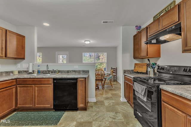 kitchen featuring sink, range hood, and black appliances