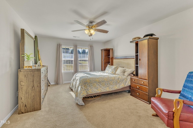 bedroom with light carpet and ceiling fan