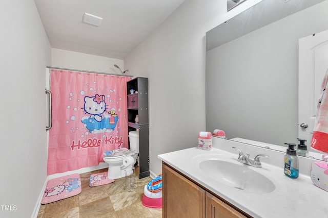 bathroom featuring toilet, vanity, and a shower with shower curtain