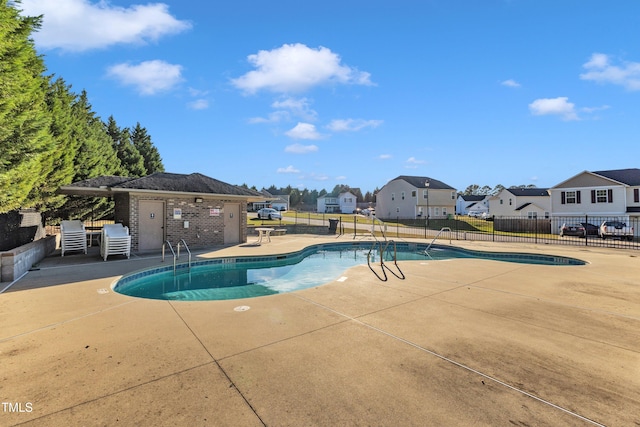 view of pool featuring a patio and an outdoor structure