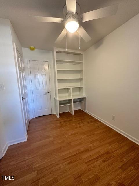 unfurnished bedroom featuring ceiling fan and dark hardwood / wood-style floors