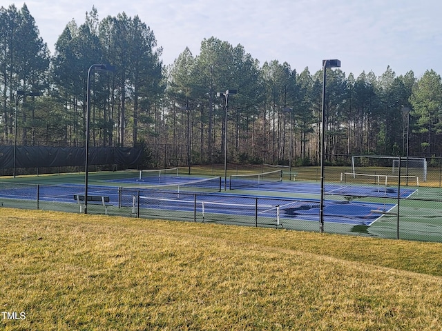 view of tennis court with a lawn