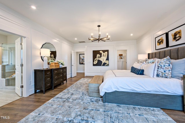 bedroom featuring dark wood-type flooring and a chandelier