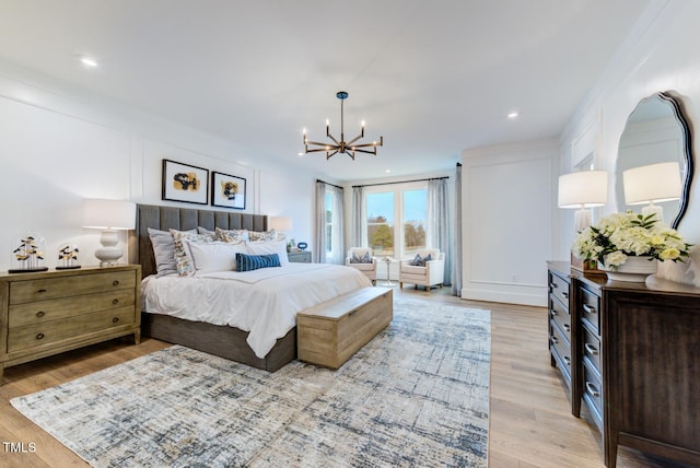 bedroom with an inviting chandelier and light wood-type flooring