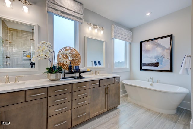 bathroom featuring vanity and independent shower and bath